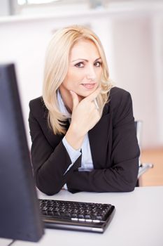 Beautiful businesswoman working on computer in the office