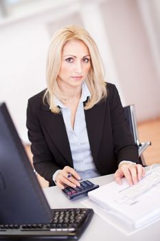 Beautiful businesswoman doing finances in the office