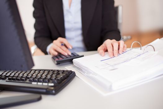Closeup of a businesswoman doing finances in the office