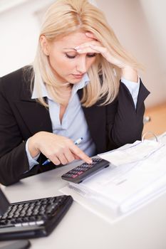 Beautiful businesswoman doing finances in the office