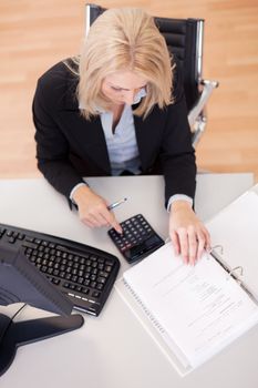 Beautiful businesswoman doing finances in the office