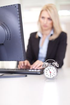 Beautiful businesswoman trying to meet a deadline in the office