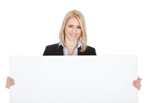 Cheerful businesswomen presenting empty board. Isolated on white