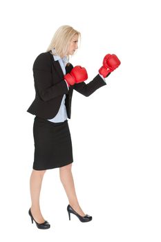 Beautiful businesswomen doing a punch. Isolated on white