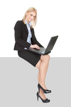 Businesswoman sitting on copyspace. Isolated on white