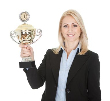 Businesswoman winning a trophy. Isolated on white