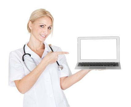 Smiling medical doctor woman presenting laptop. Isolated on white