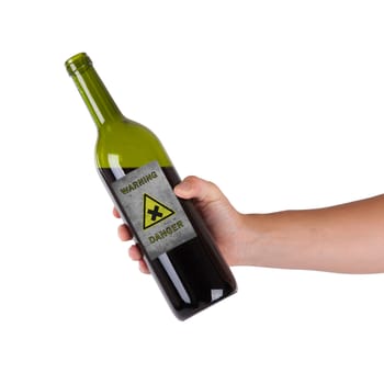 Hand holding a bottle with a warning, danger