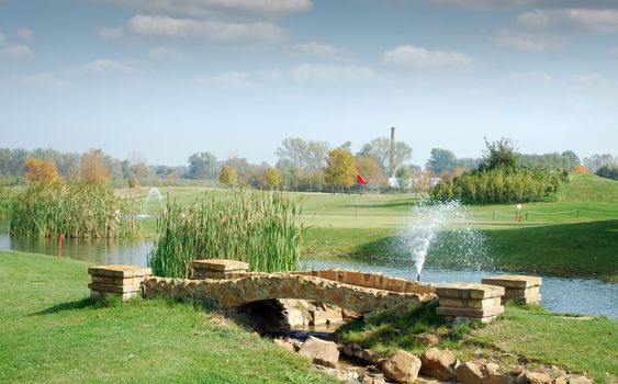 golf course with little stone bridge
