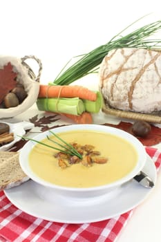 a bowl of sweet chestnut soup with roasted chestnuts and chives