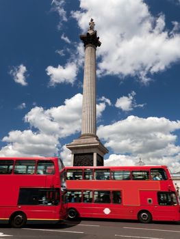 Trafalgar Square in London, the UK. Red bus in motion