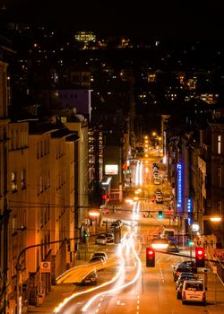 STUTTGART, GERMANY - NOVEMBER 9, 2013: Vivid night scenery showing light traces of cars passing by in long exposure at a intersections along Schwabstrasse on November 9, 2013 in Stuttgart, Germany. The crossroads between Schwabstrasse and Rotebuehlstrasse in Stuttgart West is one of the main streets in Stuttgart.