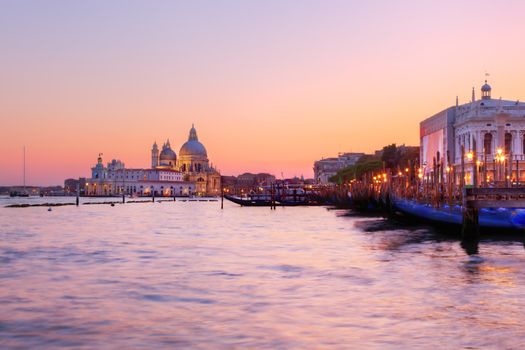 Venice, Italy. Gondolas on Grand Canal at sunset. Basilica Santa Maria della Salute in the background