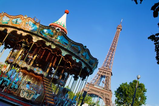 Eiffel Tower and vintage carousel at a sunny summer day, Paris, France
