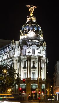 View of famous Metropolis building in Gran Via street at night, in Madrid, Spain