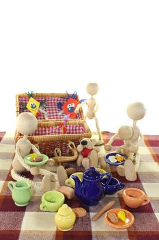 Picnic with family, kite, basket, blanket and dishes on a light background