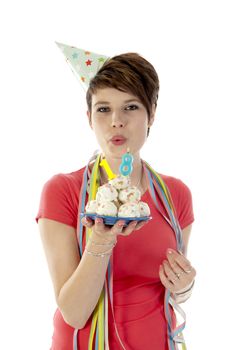 a birthday girl on her 18th birthday, holding a cake with a candle on a white background