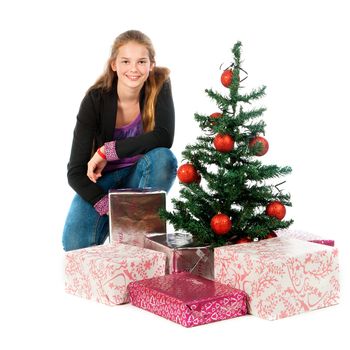 a girl with a christmas tree and a lot of presents