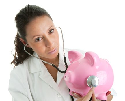 Doctor inspecting piggy bank. Isolated on white