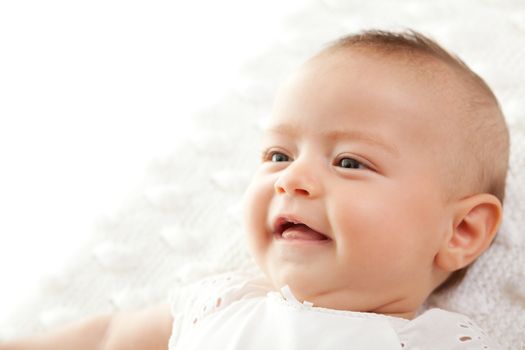 Closeup portrait of cute little baby girl smiling