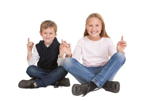 Cute kids doing yoga exercise. Isolated on white