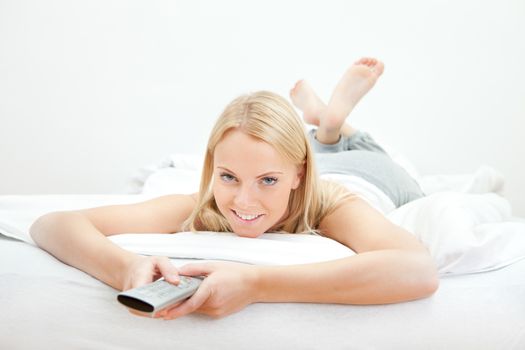 Young beautiful woman lying in bed at home