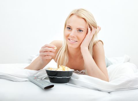 Young beautiful woman lying in bed at home