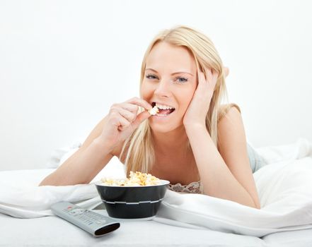 Young beautiful woman lying in bed at home