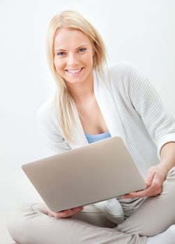 Beautiful woman working on computer sitting on floor
