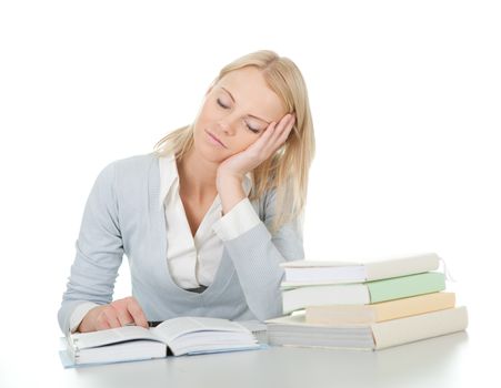 Beautiful student girl tired from doing homework at the desk. Isolated on white