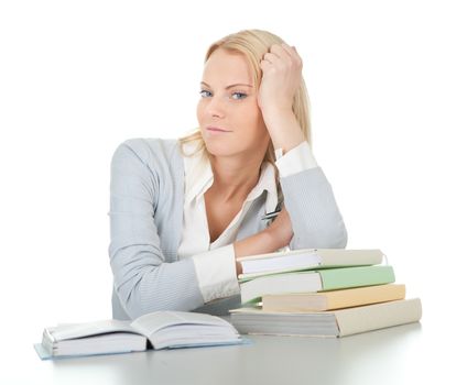 Beautiful student girl doing homework at the desk. Isolated on white
