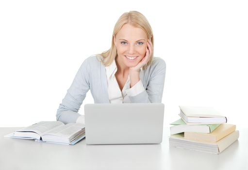 Beautiful student girl studying with laptop at the desk. Isolated on white