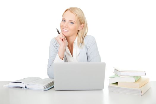 Beautiful student girl studying with laptop at the desk. Isolated on white