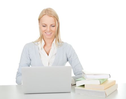 Beautiful student girl studying with laptop at the desk. Isolated on white