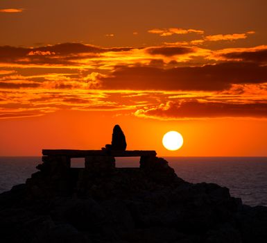 Ciutadella Menorca at Punta Nati orange sunset with girl backlight