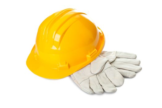 Safety yellow hard hat and industrial gloves isolated on white background