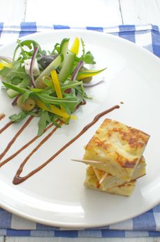Potato omelette on a plate with a salad 