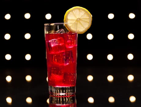 Red Campari Cocktail in longdrink glass with lemon decoration