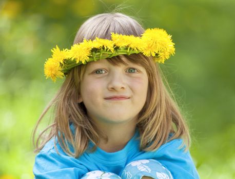 portrait of a boy with long blond hair and flower wreaths