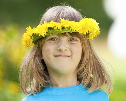 portrait of a boy with long blond hair and flower wreaths