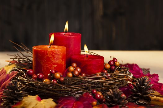 Candles in nice and beautiful colorful autumn leaves