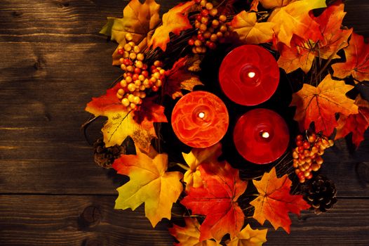 Candles in nice and beautiful colorful autumn leaves