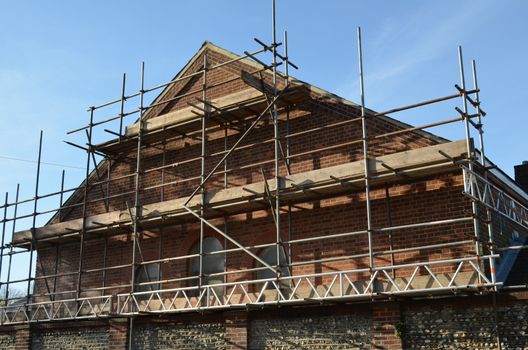 Scaffolding around a buildings gable.