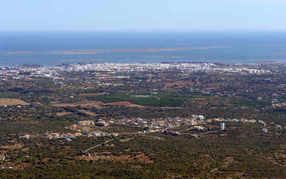 Ria Formosa ecosystem view from the hill, city of Olhao in the shoreline and "Farol" island in the background