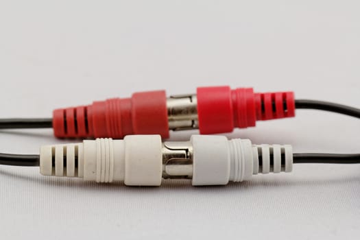 correct conection between left - right audio RCA cable on a white background (red white)