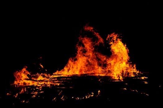 red flames of huge bonfire or campfire as black backgorund