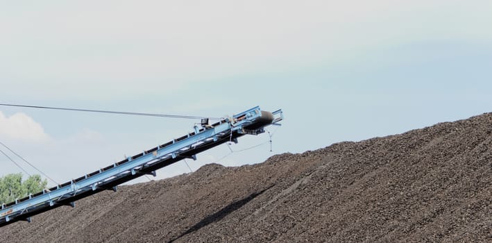 Coal mining in an open pit with huge industrial machine