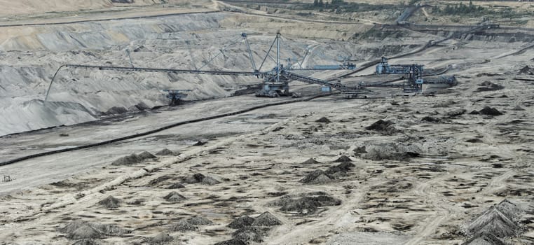 Coal mining in an open pit with huge industrial machine