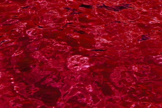 red abstract background of wavy water surface