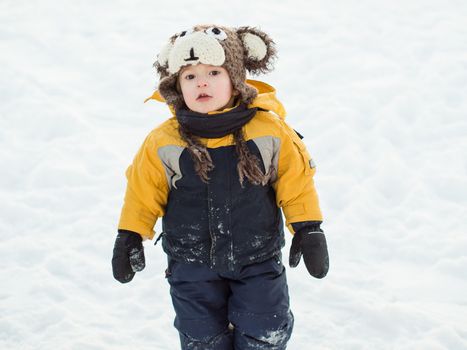 Infant boy playing in the snow